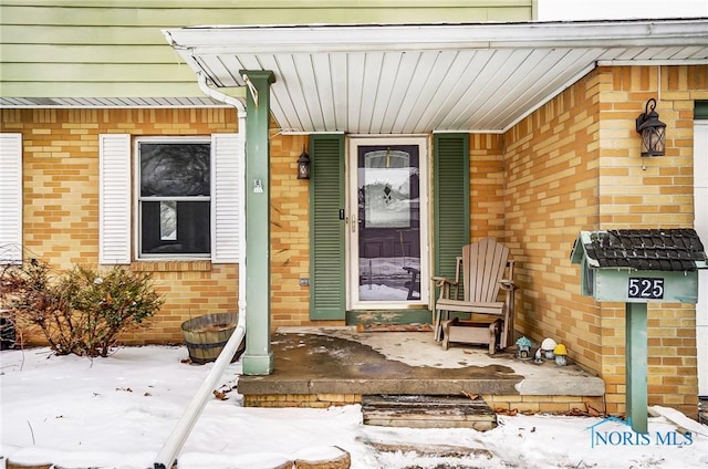 view of snow covered property entrance