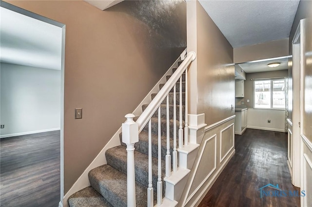 stairway with hardwood / wood-style floors