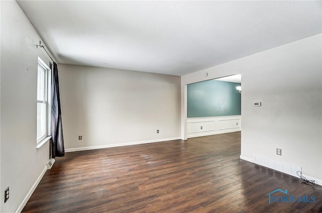 empty room with dark wood-type flooring