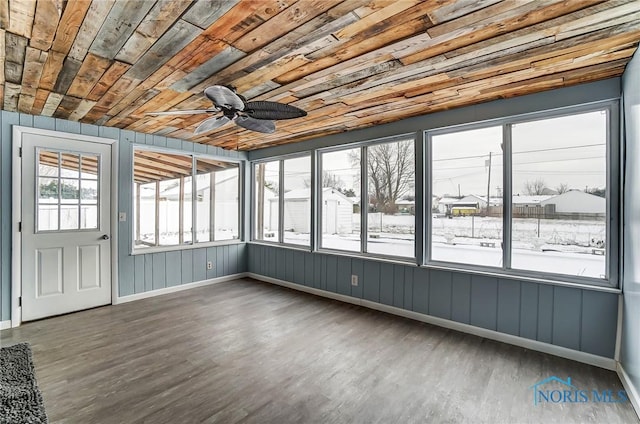 unfurnished sunroom featuring wood ceiling and ceiling fan