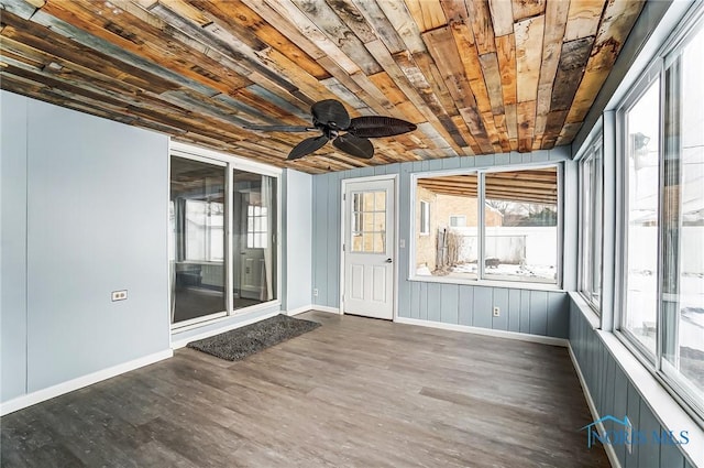 unfurnished sunroom featuring wooden ceiling and ceiling fan