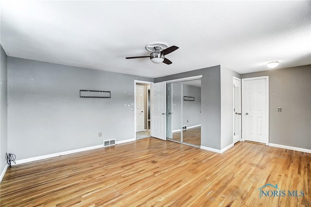 unfurnished bedroom with light hardwood / wood-style floors and ceiling fan