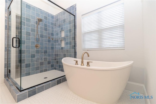 bathroom featuring tile patterned floors and shower with separate bathtub