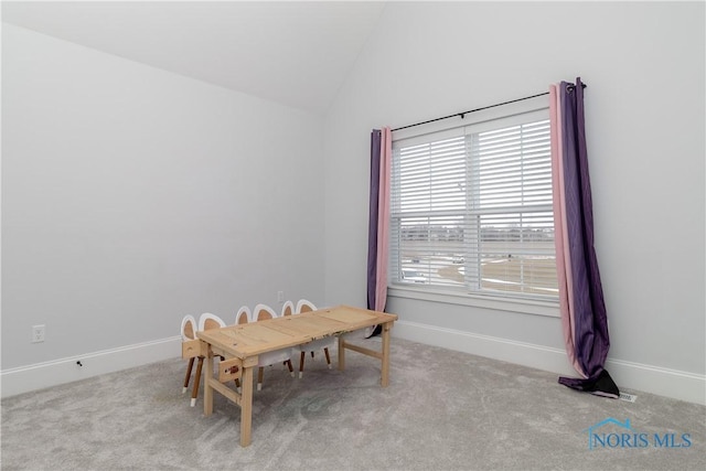 interior space featuring lofted ceiling and light carpet