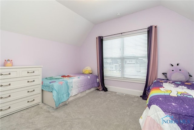 bedroom with lofted ceiling and light carpet