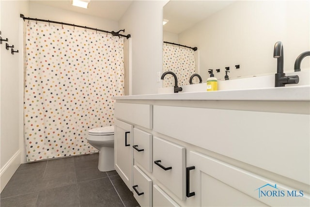 bathroom with vanity, toilet, curtained shower, and tile patterned flooring