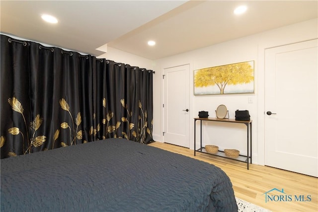 bedroom with hardwood / wood-style flooring