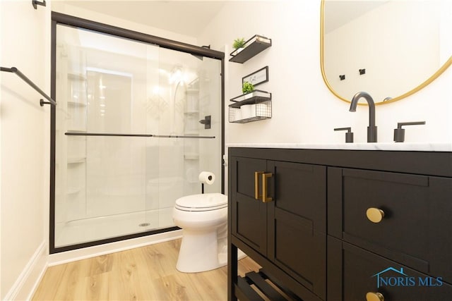 bathroom with vanity, an enclosed shower, hardwood / wood-style flooring, and toilet