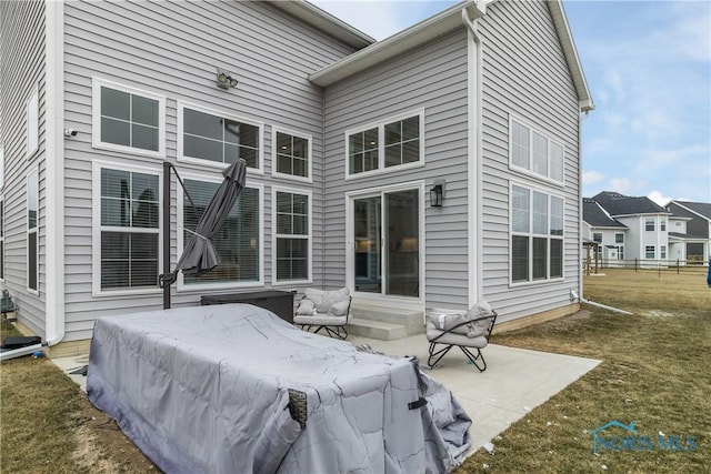 rear view of property with a patio area and a lawn