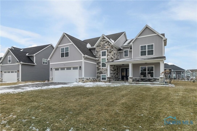 craftsman-style home with a garage, covered porch, and a front yard