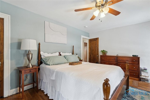 bedroom with baseboards, dark wood finished floors, and a ceiling fan