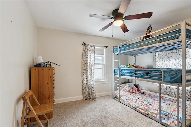 bedroom with ceiling fan, baseboards, and carpet