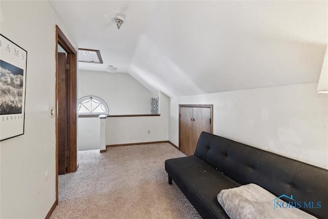 sitting room featuring baseboards, lofted ceiling, and carpet floors
