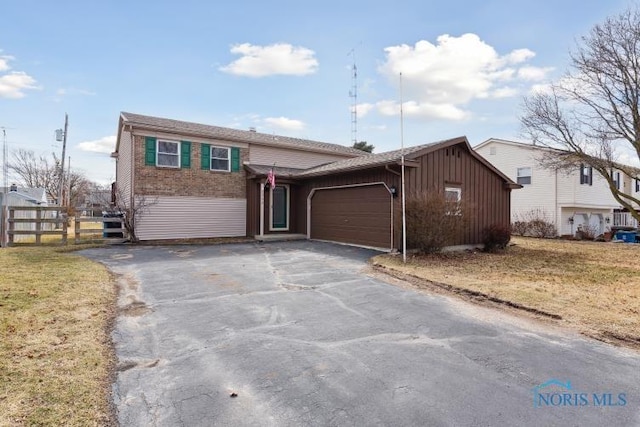 view of front of home featuring a garage, aphalt driveway, board and batten siding, and fence