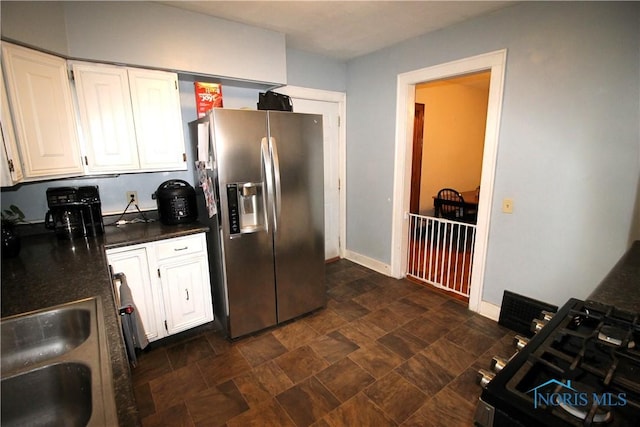 kitchen featuring white cabinetry, sink, and stainless steel fridge with ice dispenser