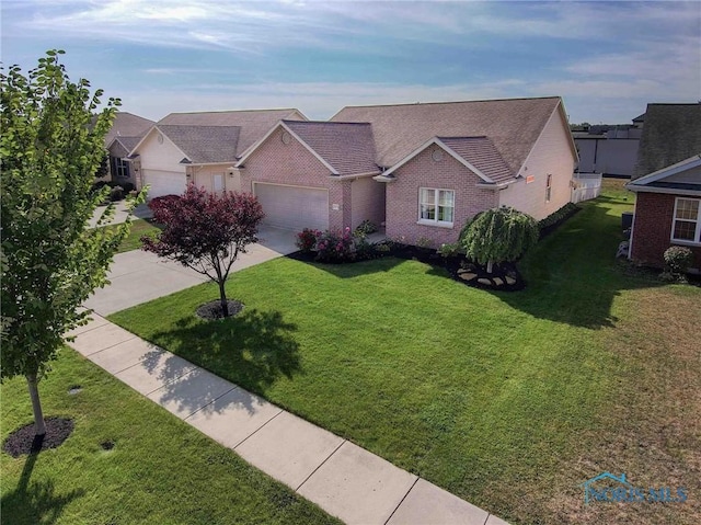 view of front of property with a garage and a front yard