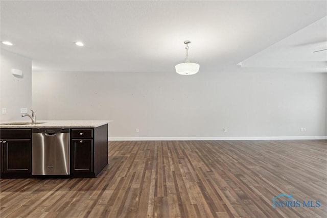 kitchen with pendant lighting, light countertops, stainless steel dishwasher, a sink, and dark brown cabinetry