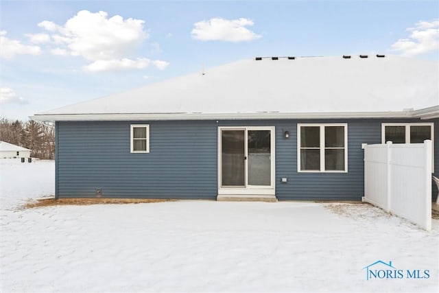 snow covered property with entry steps