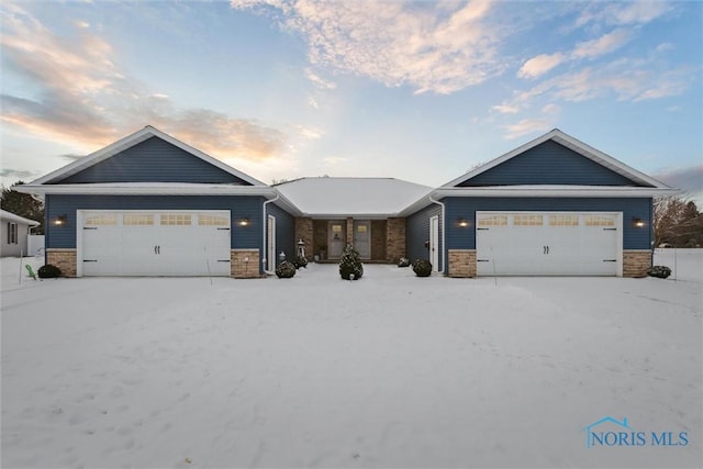 view of front of house featuring stone siding and an attached garage