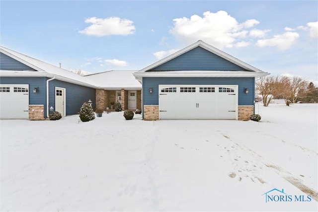 view of front of house featuring a garage and stone siding