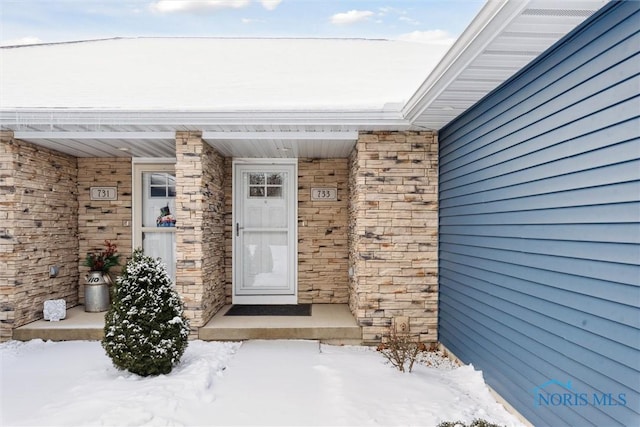 view of snow covered property entrance