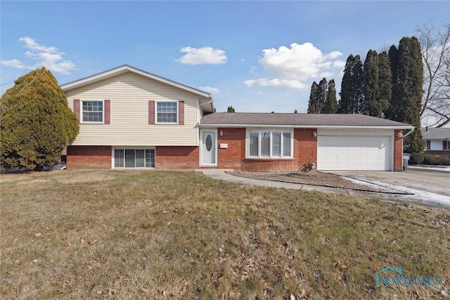 tri-level home featuring a garage and a front yard