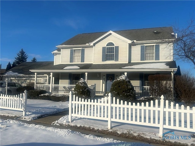 view of front of house with covered porch and a fenced front yard