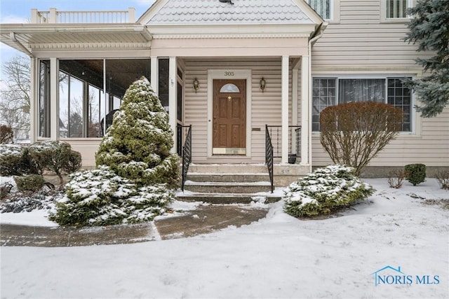 view of snow covered property entrance