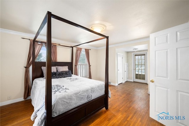 bedroom with hardwood / wood-style flooring and crown molding