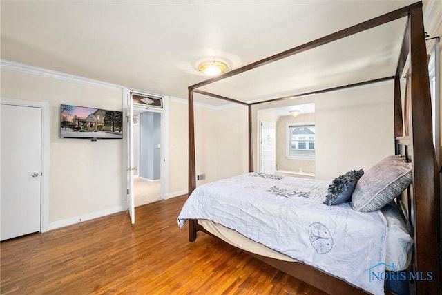 bedroom featuring crown molding and hardwood / wood-style floors