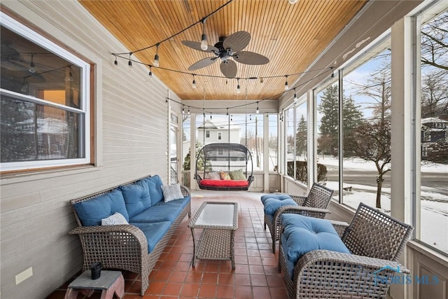 sunroom / solarium with ceiling fan and wood ceiling