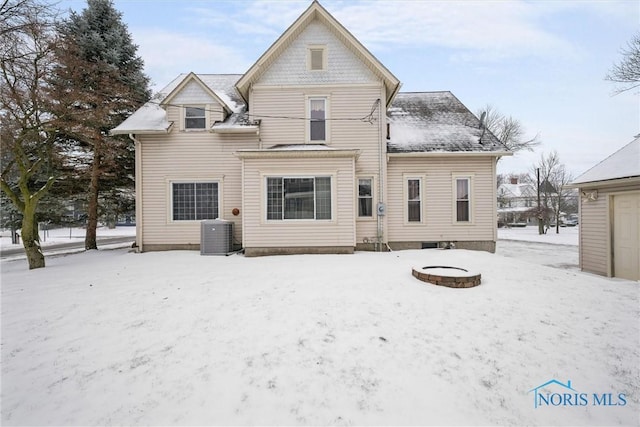 snow covered property featuring central air condition unit