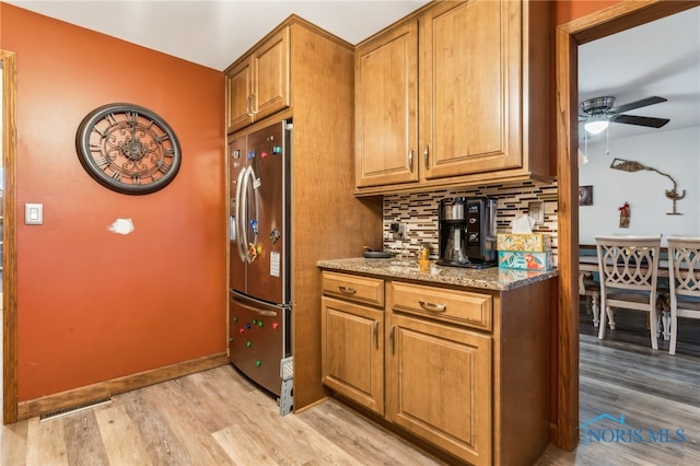 615 Lincolnshire Ln, Findlay, OH 45840 - kitchen with tasteful backsplash, light stone countertops, stainless steel fridge, and light hardwood / wood-style floors