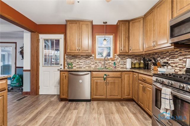 615 Lincolnshire Ln, Findlay, OH 45840 - kitchen featuring sink, light hardwood / wood-style flooring, pendant lighting, stainless steel appliances, and light stone countertops