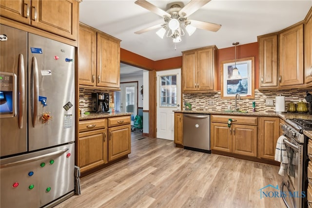 615 Lincolnshire Ln, Findlay, OH 45840 - kitchen featuring sink, appliances with stainless steel finishes, hanging light fixtures, light hardwood / wood-style floors, and dark stone counters