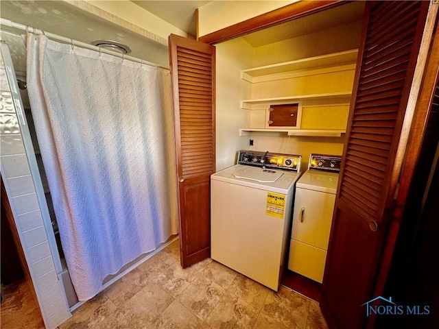 washroom featuring washer and dryer