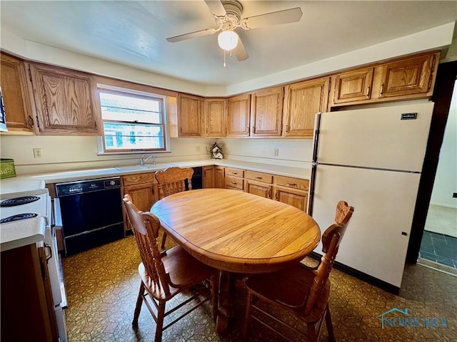 kitchen featuring dishwasher, sink, white fridge, stove, and ceiling fan