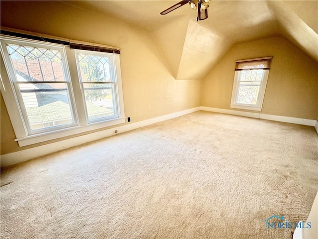 additional living space featuring ceiling fan, lofted ceiling, and carpet