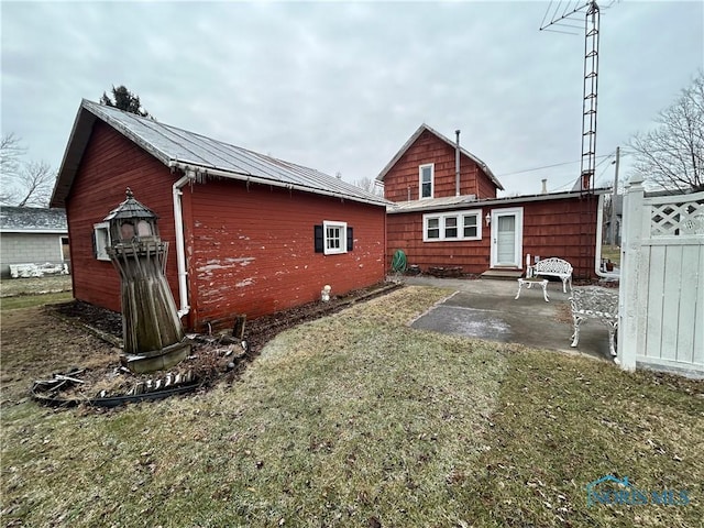 back of house with a patio and a yard