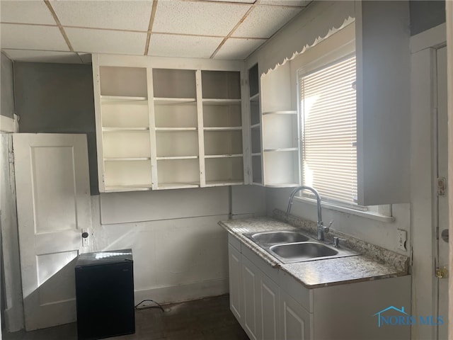 kitchen with a drop ceiling and sink