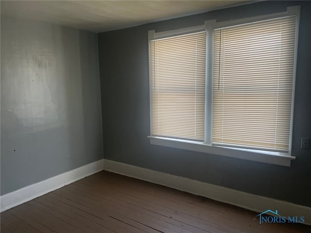 spare room with hardwood / wood-style floors