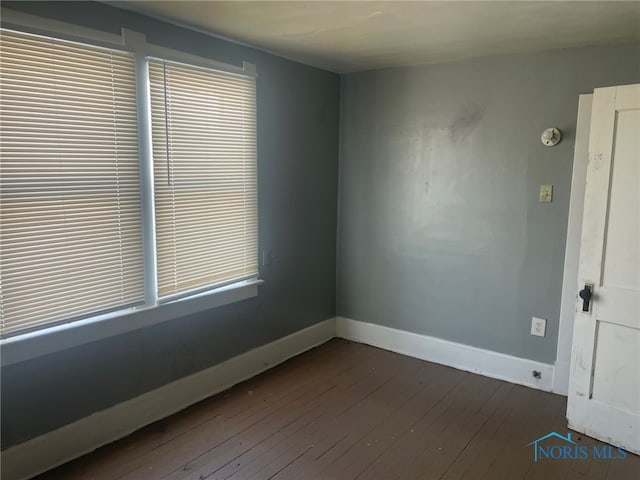 spare room featuring dark hardwood / wood-style floors