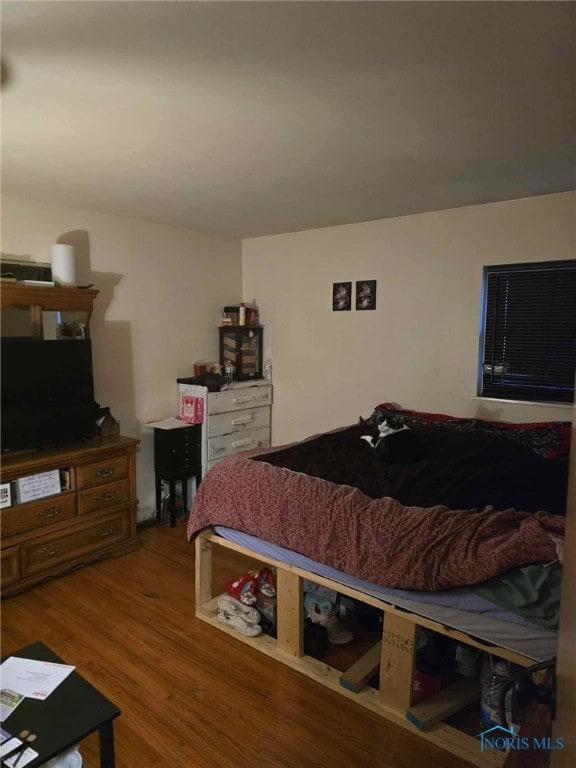 bedroom featuring wood finished floors