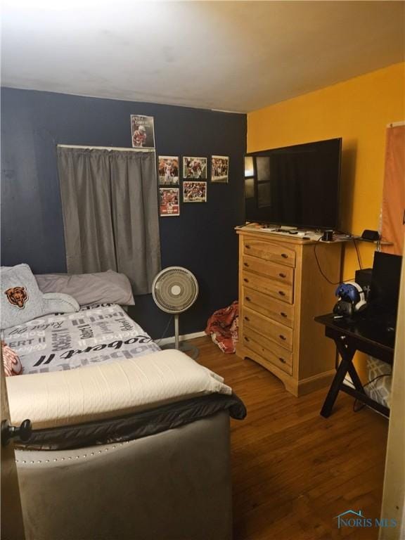 bedroom with dark wood-style floors