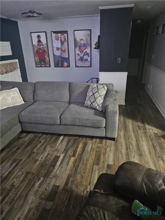 living area with dark wood-type flooring and wainscoting