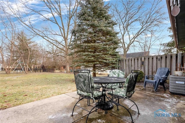 view of patio featuring central AC and a playground