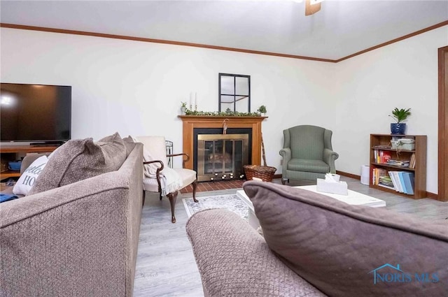 living room featuring crown molding and light hardwood / wood-style flooring