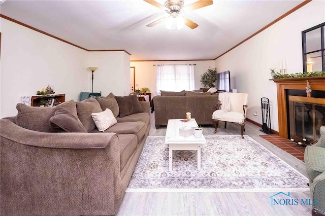 living room featuring hardwood / wood-style flooring, crown molding, and ceiling fan