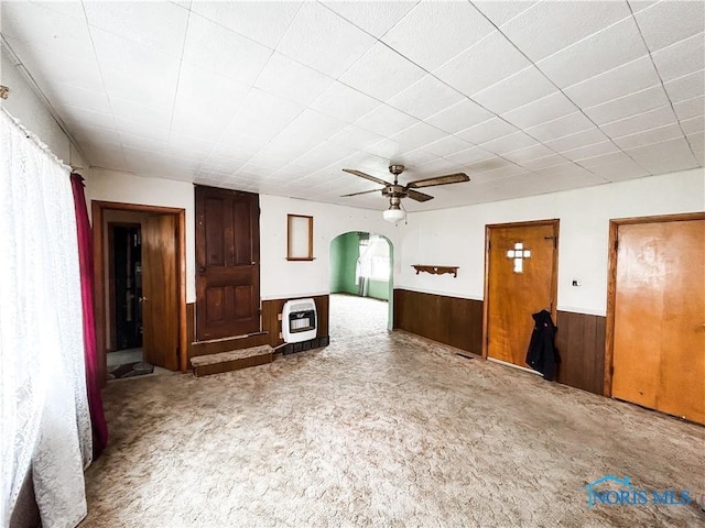 12356 Sylvania Metamora Rd, Berkey, OH 43504 - unfurnished living room with ceiling fan, carpet flooring, heating unit, and wooden walls