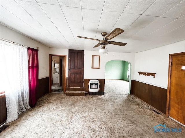 12356 Sylvania Metamora Rd, Berkey, OH 43504 - spare room with ceiling fan, carpet floors, heating unit, and wood walls